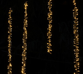 Background of Vertical Christmas Lights Hanging in the dark