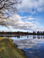 Wolken spiegeln sich im See