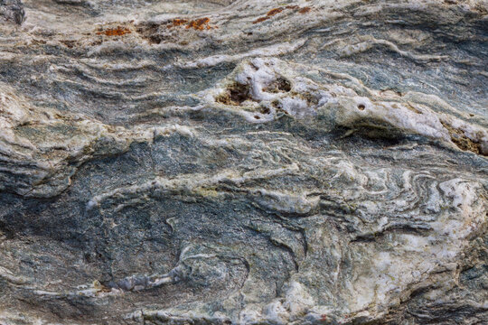 A close-up of schist reveals layered mineral textures shaped by heat and pressure&mdash;nature&rsquo;s geological memory.