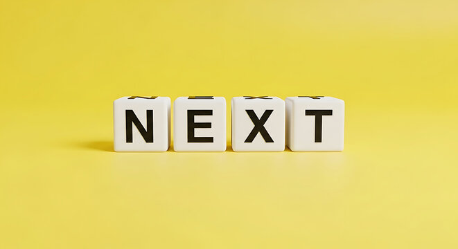 Four white cubes spelling out the word next in black capital letters on a bright yellow background