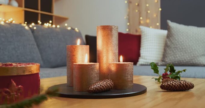 Christmas Home Decorations &ndash; A Woman is Lighting the Fourth Candle of a Minimalist Advent Arrangement