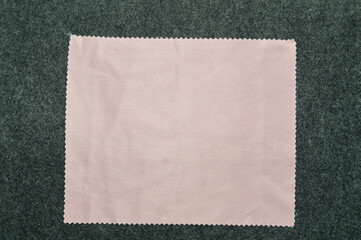 Obraz premium Flat lay of full pink microfiber cleaning cloth. Focus on texture and zig-zag edges. Excellent background for textile, product care, or hygiene concepts.