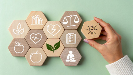 A collection of wooden hexagonal blocks arranged in a honeycomb pattern, each block displays a white icon related to health and wellness