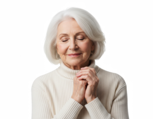 Serene senior woman with white hair and closed eyes, hands clasped in contemplation while wearing a cream turtleneck