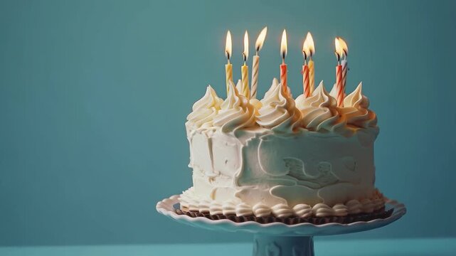 A festive cake with burning candles and delicate cream frosting embodies joy and warmth, becoming a bright backdrop for greeting cards or culinary blogs.
