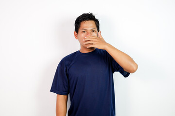 Young Man In Navy T-Shirt Covering Mouth With Hand, Expressing Surprise Or Silence