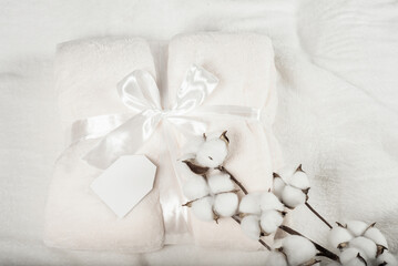 soft surface of a fluffy plaid with a mockup sign for an inscription, with a gift ribbon. fluffy...