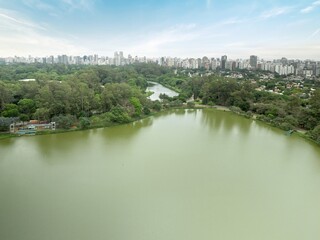 Fototapeta premium Aerial view of Ibirapuera Park in São Paulo, Brazil, with a serene lake and cityscape