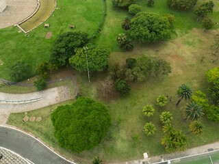 Aerial view of a lush green park with trees and walking paths