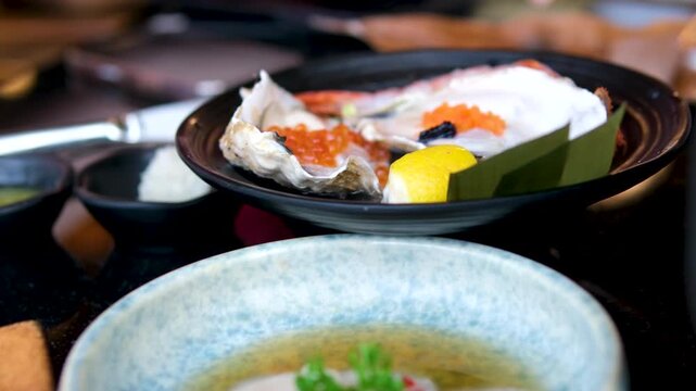 Carnegie dinner at a sushi restaurant red fish, white fish, butterfish, halibut, escallops, raw fish, oysters. High quality 4k footage