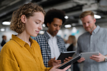 A diverse team collaborating on a project in a modern workspace.