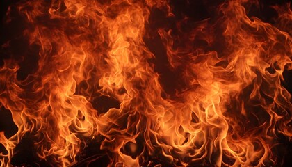 A close-up view of intense, vibrant orange and yellow flames engulfing a dark background, showcasing the dynamic and destructive nature of fire.