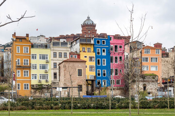 Colorful historic houses on the Golden Horn waterfront with vibrant facades and old architecture creating a lively urban scene. Istanbul, Turkey.