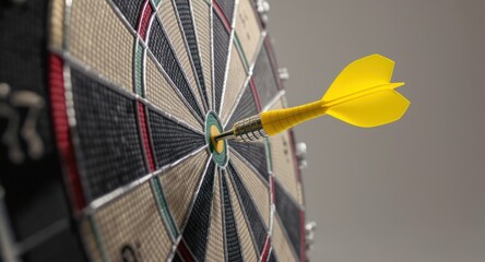 Close-up shot of a dart hitting the bullseye on a dartboard, yellow dart prominent