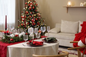 Festive table setting with Christmas decor indoors