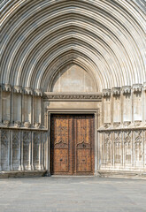 Decorative entrance door to a Gothic church, ancient cathedral gate