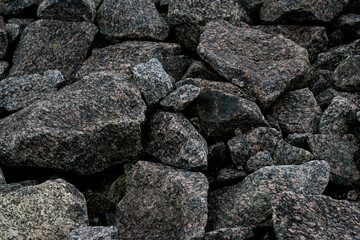 Coarse stones displaying weathered edges and diverse mineral colors