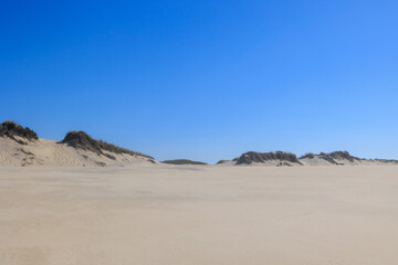 Wide sandy dunes under a clear blue sky forming a natural coastal landscape Portugal, Ovar – Furadouro, 10.10.2025