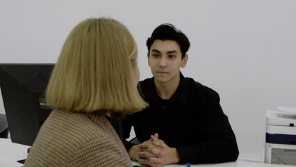 Close-up of a client and manager discussing documents 
