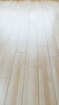 Empty room interior with a polished light wooden floor. The surface reflects light, creating a clean and spacious background for design