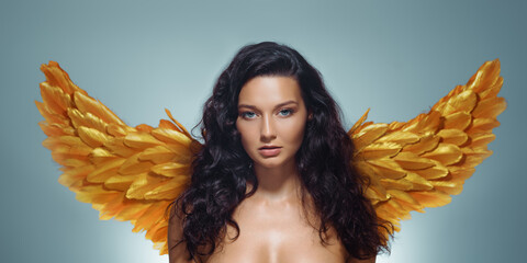 Glamorous Woman With Glowing Skin And Gold Wings In Fantasy Beauty Shot