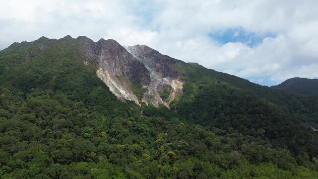 A geothermal volcanic mountain with sulfur fumaroles and rising steam seen from above