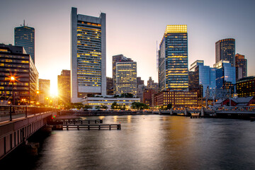 Boston in Massachusetts, USA at sunset with the skyscrapers of the Boston Harbor and Financial District.