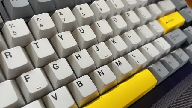 Computer keyboard with a bright yellow key symbolizing business technology and web communication concept