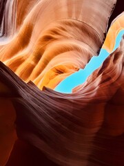 Antelope Canyon&rsquo;s twisting sandstone walls glow with red and orange hues beneath a vivid blue sky, 3 December 2025 Arizona, USA.