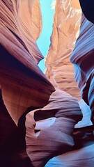 Antelope Canyon&rsquo;s twisting sandstone walls glow with red and orange hues beneath a vivid blue sky, 3 December 2025 Arizona, USA.