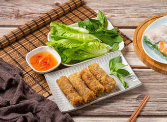 Crispy spring rolls with fresh herbs and dipping sauce ready to eat in a delicious and inviting meal presentation