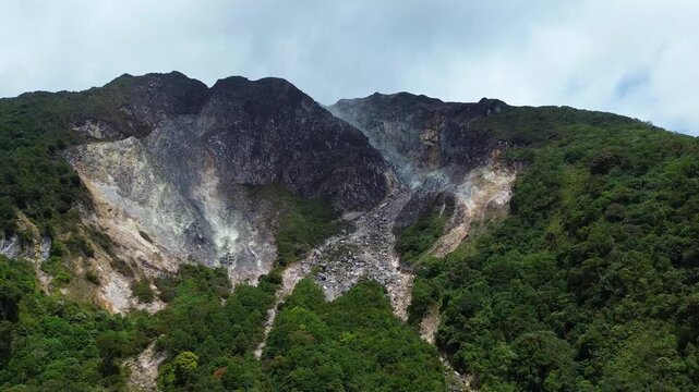 A dramatic volcanic mountain with active fumaroles viewed from above