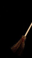 Mini witch brooms on black background, occult props, mystical composition, esoteric tools for magic and rituals