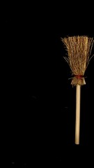 Mini witch brooms on black background, occult props, mystical composition, esoteric tools for magic and rituals