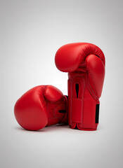 Red boxing gloves on grey background in commercial style  