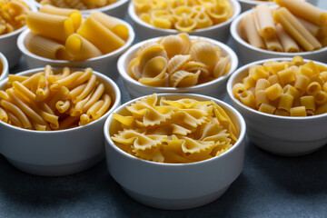 Composition with different tasty uncooked pasta - Italian pasta wallpaper, different types and shapes of pasta layout