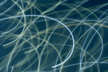 Abstract light trails form circles against a dark background