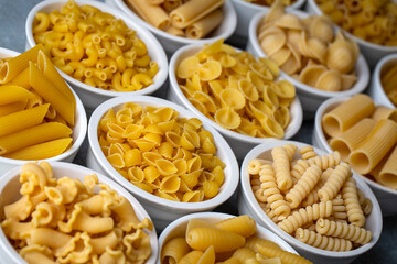Composition with different tasty uncooked pasta - Italian pasta wallpaper, different types and shapes of pasta layout