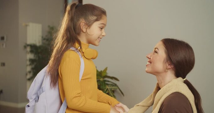 Little girl excitedly embraces her mother in warm farewell
