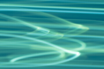 A blue background with a greenish shimmer from streaks of light.