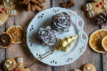 On the table there is New Year's tea 2026, coffee, gingerbread and pine cone cookies.