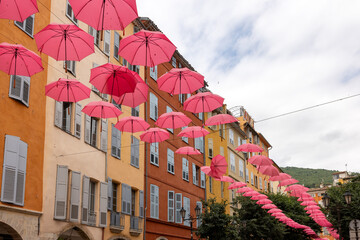 Streets of Grasse, a city known for its perfumery, decorated with pink umbrellas on the occasion of the annual international exhibition of roses - Expo Rose.