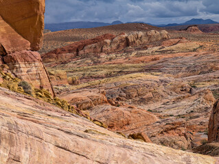 Colorful layered sandstone formations in Valley of Fire desert landscape under dramatic cloudy sky