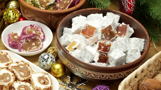 Beautiful and festive background for New Year holidays with candies and sweets and decorations, Sweet food Turkish delight on wooden background, assorted locum and candy for decorated backdrop
