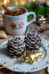 On the table there is New Year's tea 2026, coffee, gingerbread and pine cone cookies.