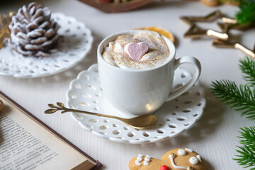 On the table there is New Year's tea 2026, coffee, gingerbread and pine cone cookies.