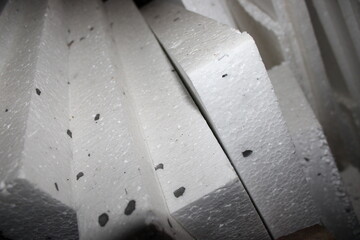 Pieces of white foam stacked in a workspace for future use in construction or insulation projects