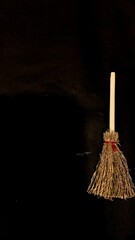 Mini witch brooms on black background, occult props, mystical composition, esoteric tools for magic and rituals
