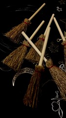 Witch brooms and magical symbols on black background occult charms, moon, stars and pentagram for mystical rituals and witchcraft