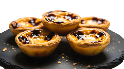 Creamy Portuguese custard tarts styled on a slate plate with soft café illumination, captured in a warm indoor bakery setting. Isolated on White background